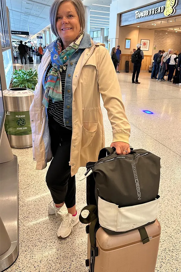Beige Jacket Layered Over A Casual Travel Look