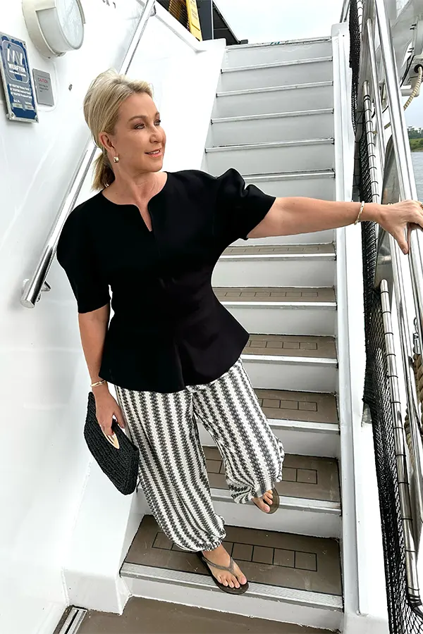 Black Top And Striped Trousers With A Casual Edge