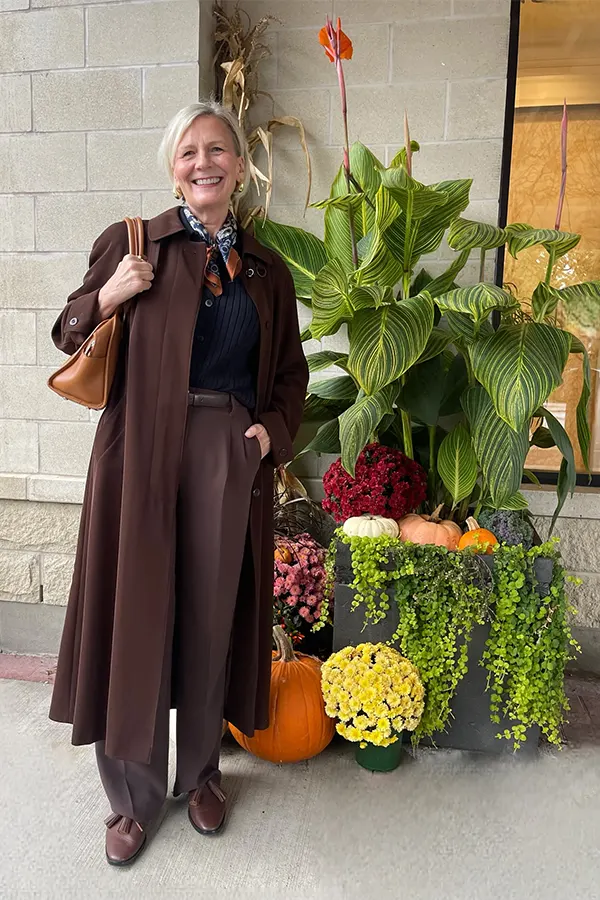 Layer A Long Brown Coat Over A Soft Monochrome Base