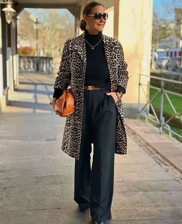Leopard Coat Over A Black Turtleneck And Wide Trousers