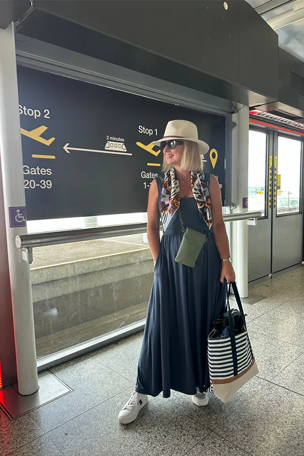 Long Navy Dress With Hat For Elegant Airport Style