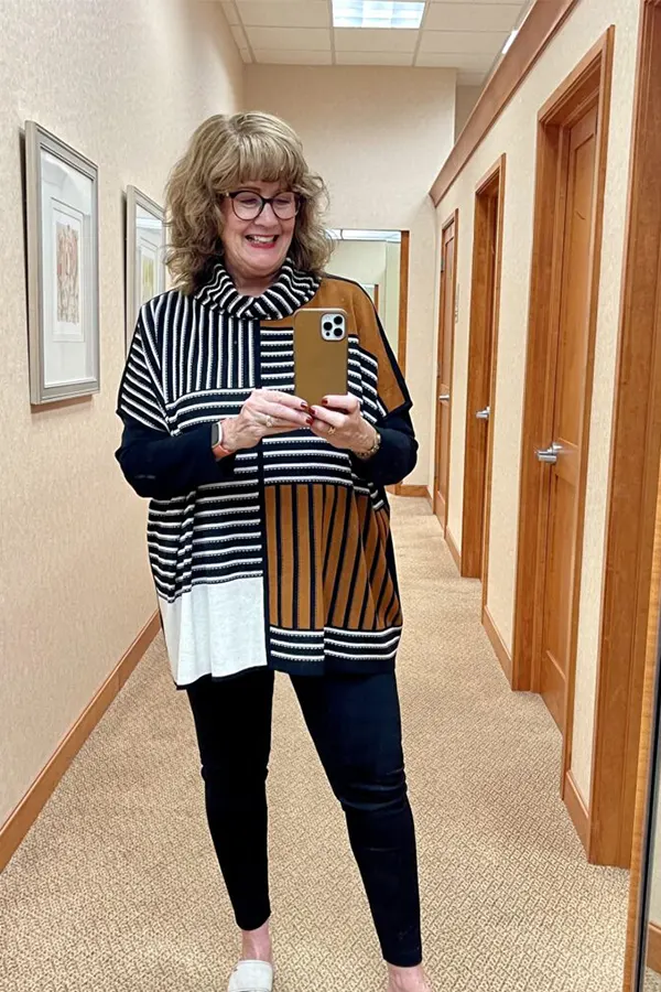 Use A Striped Layer To Add Interest To Black Leggings