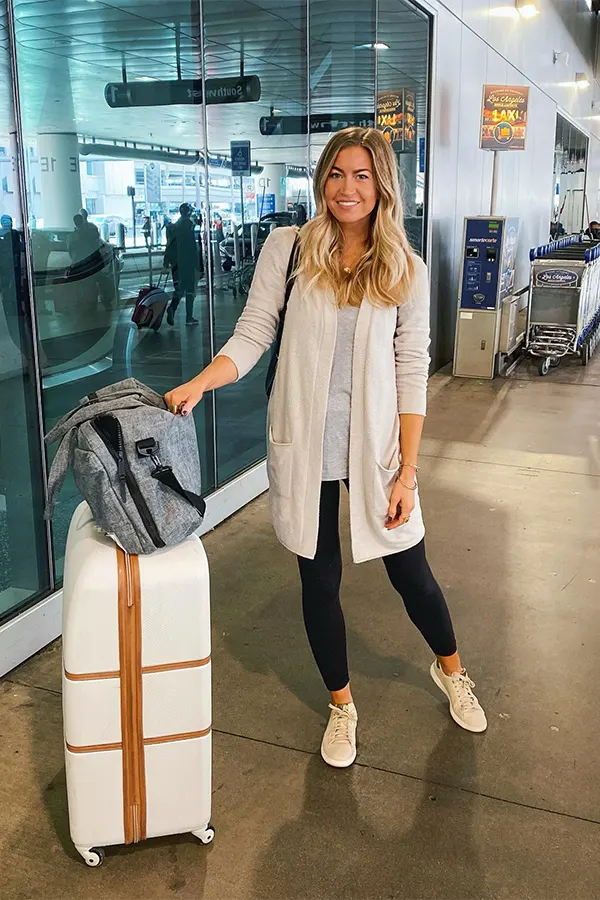 White Cardigan With Black Leggings For Easy Flight Comfort