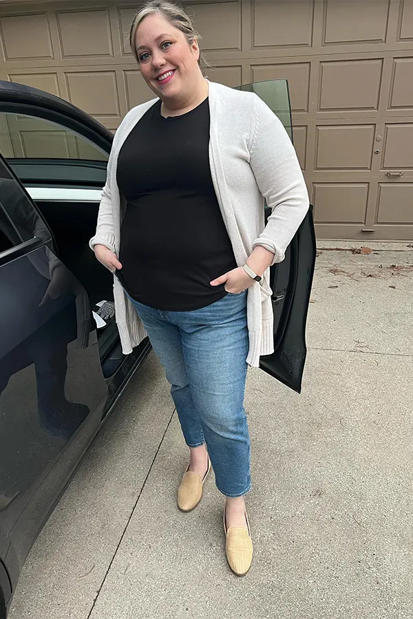 A Black Top With A Long White Cardigan And Slim Jeans