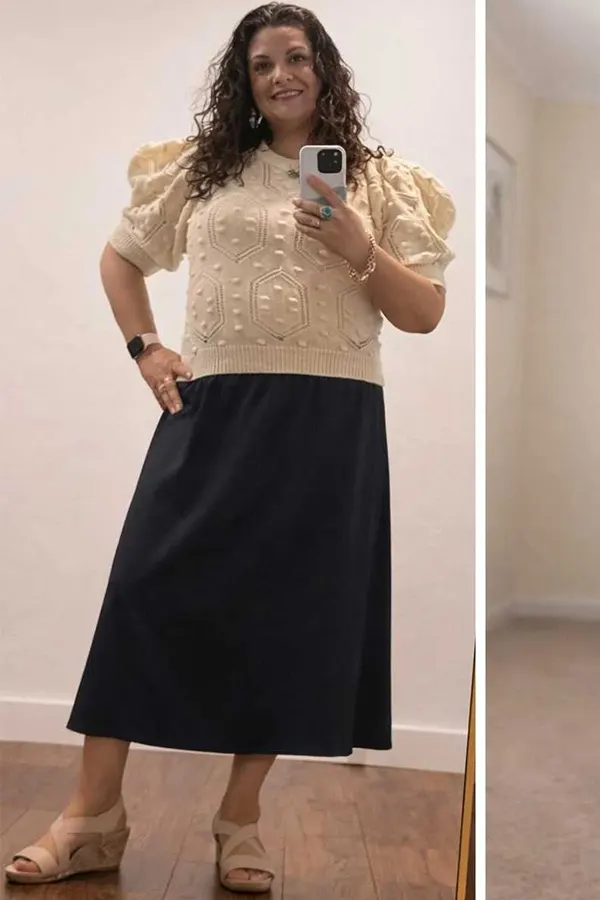 A Cream Textured Top Paired With A Full Black Skirt