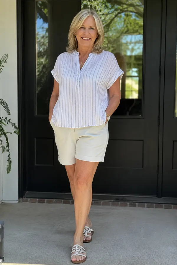 A Light Striped Blouse With White Shorts
