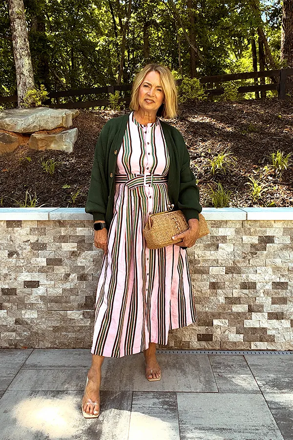 Layer A Dark Green Cardigan Over A Striped Midi Dress