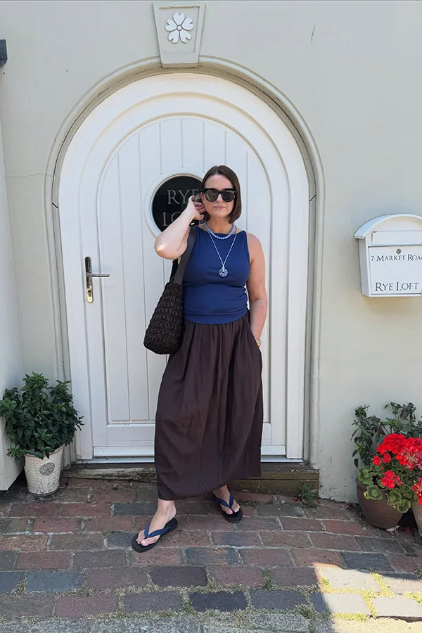 Sleeveless Navy Top With A Full Midi Skirt