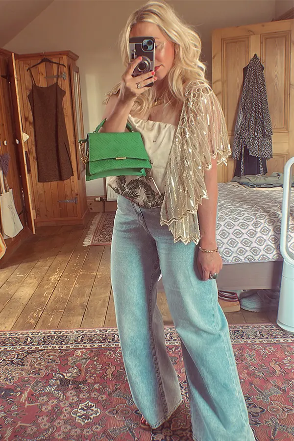 Sparkly Layer With Wide Leg Jeans And A Green Bag