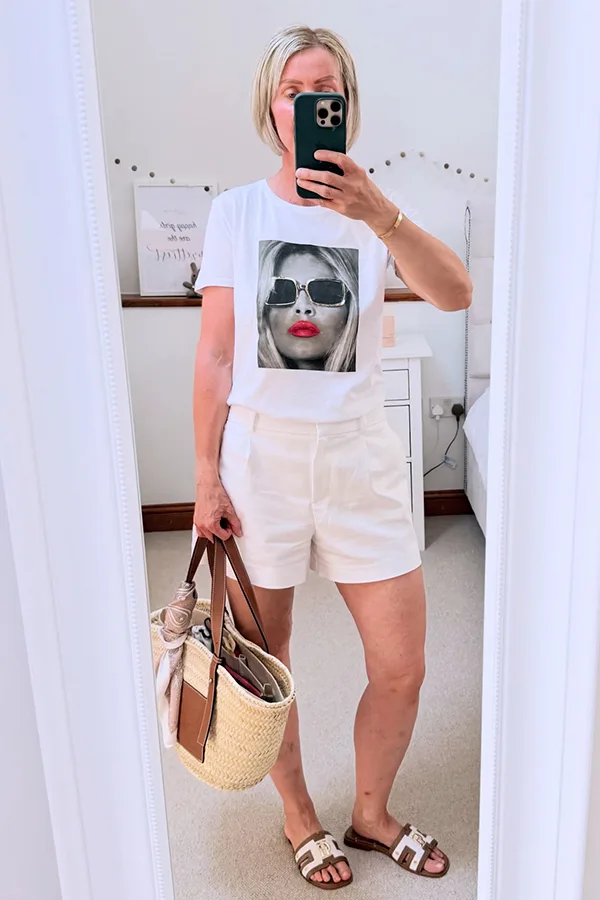 White Graphic Tee With White Jorts And A Woven Bag