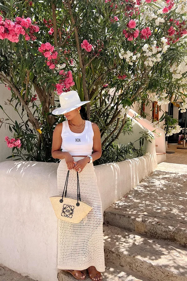 White Tank Top And Flowing Skirt With A Wide Brim Hat