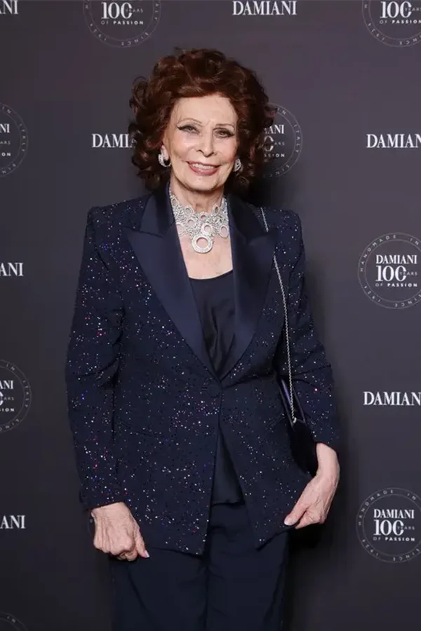 Dark Tailored Suit With Statement Jewelry
