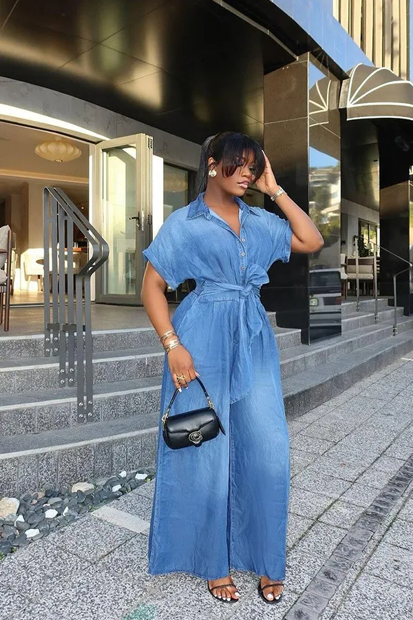 Light Blue Wide Leg Jumpsuit With A Small Handbag